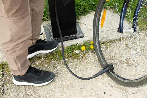 Wallpaper Mural Close-up of feet and bike pump nozzle at a repair station. Torontodigital.ca
