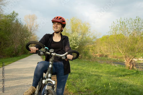 Wallpaper Mural Fitness and recreation, young woman enjoying a bicycle ride in the spring park Torontodigital.ca