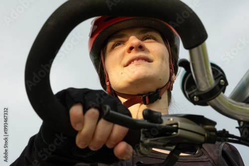 Wallpaper Mural Woman cyclist holding handlebars against the sky, active lifestyle concept Torontodigital.ca