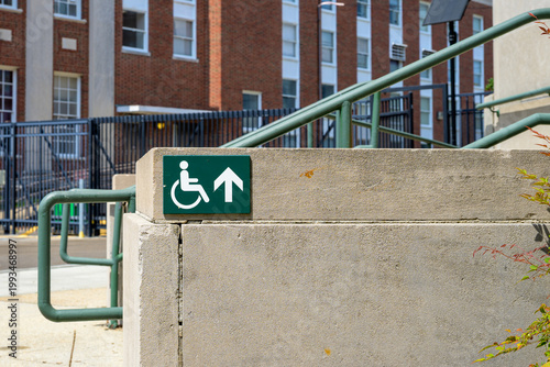 Selective Focus of Wheelchair Accessible Sign on Steps of University Building