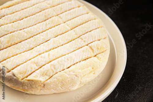 Soft cheese Camembert, Brie, or Coulommiers cheese head tasty snack fresh gourmet food background on the table rustic food top view copy space marketing concept photo