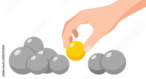 Hand Picking Yellow Marble from Gray Stones for Creativity and Play
