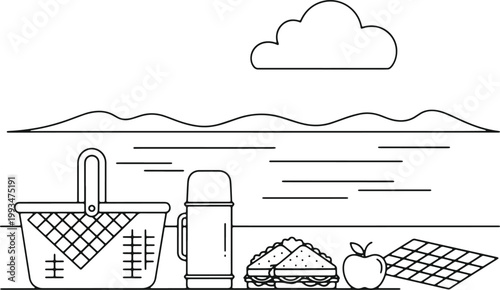 Picnic basket with thermos sandwich apple and checkered mat in park.