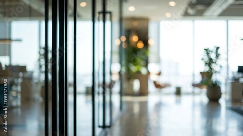 Blurred modern office interior background with large windows and indoor plants creating a bright and professional workspace atmosphere