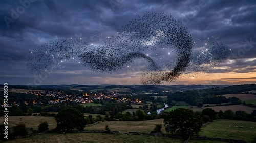 A large flock of birds forms a mesmerizing murmuration in the sky above a serene countryside landscape at dusk with a town in the background