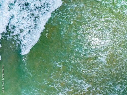 Beautiful wave crashing on sandy shore at beach in phuket thailand