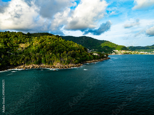Aerial flying drone view seashore waves water surface texture in sunny tropical ocean at Phuket island Thailand