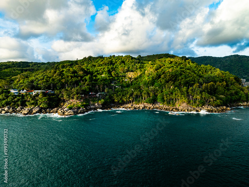 Aerial flying drone view seashore waves water surface texture in sunny tropical ocean at Phuket island Thailand