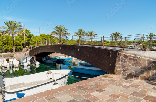 Фотография The characteristic wooden bridge over the Porto Pino canal, located in the municipality of Sant'Anna Arresi, Sardinia, Italy