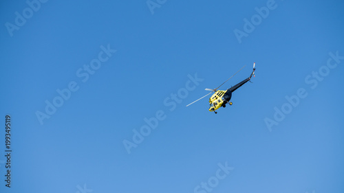 yellow helicopter in flight