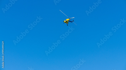 yellow helicopter in flight