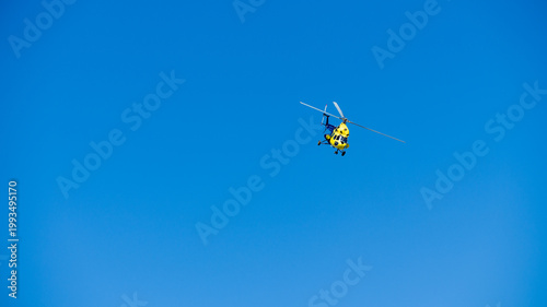 yellow helicopter in flight