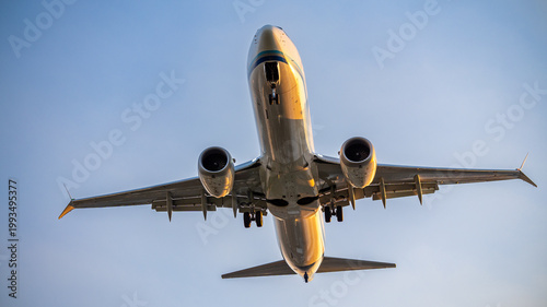 Passenger airplane approaching for landing against clear sky, front view