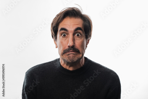 Surprised man expressing confusion with a quirky facial expression