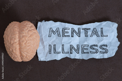 Mental Health Concept with Brain Model and “Mental Illness” Text on Torn Paper