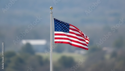Tattered United States Flag Flapping on Tall Pole in Open Field