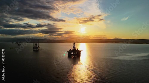 Aerial drone view of oil rigs at sunset in Cromarty Firth, Highlands, Scotland