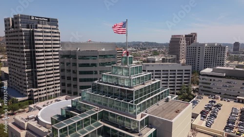 rising over American flag view of downtown Glendale CA