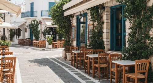 Stone street with outdoor tables and white buildings