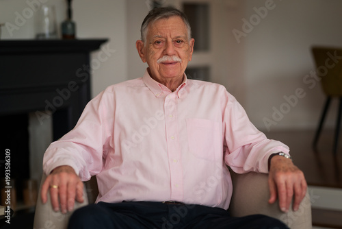 Portrait of a senior man relaxing in an armchair at home