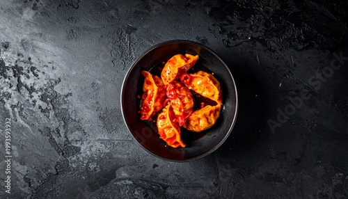 Spicy Szechuan Dumplings in Vibrant Red Chili Oil, Glistening and Served in a Dark Bowl
