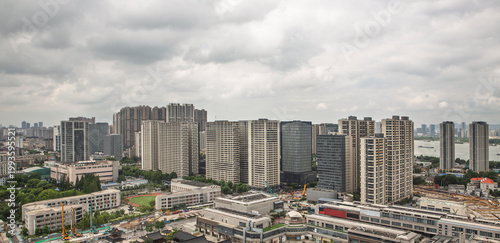 Photography Modern cityscape of Nanjing with high rise buildings under cloudy sky