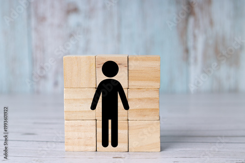 Symbol of a man or icon of a woman on a wooden cube.