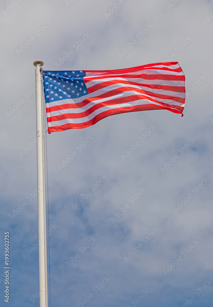 Obraz premium Flag of the United States of America at Tall Mast Clouds