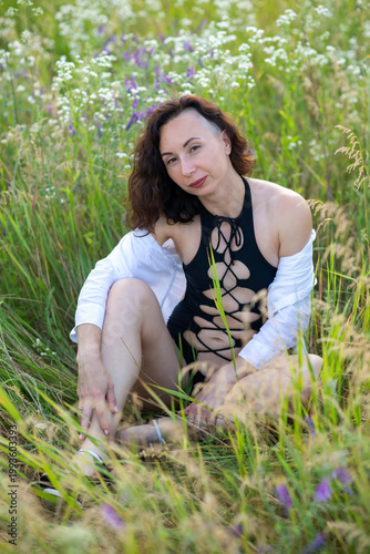 Woman in Lace-Up Swimsuit Relaxing in Wildflower Meadow
