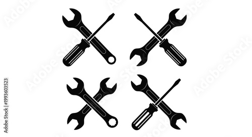 Black wrenches and screwdrivers crossed in four sets