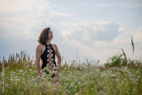 Woman in Black Cutout Swimsuit in Wildflower Meadow