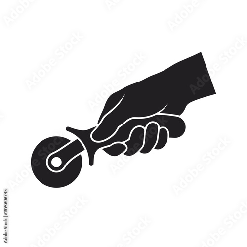 Black hand holding a pizza cutter wheel