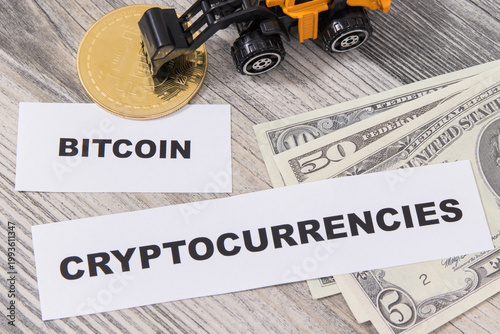 Bitcoin, miniature excavator and dollar bills. Cryptocurrency. International network payment. Finance concept