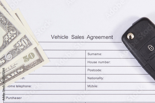 Car key, dollar banknotes and vehicle sales agreement. Sales, purchases of automobile. Transportation