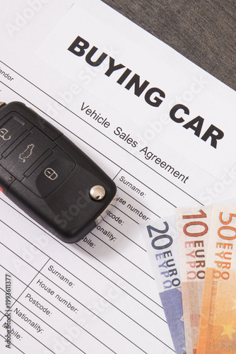 Car key, euro banknotes and vehicle sales agreement. Inscription buying car. Sales, purchases of automobile. Transportation