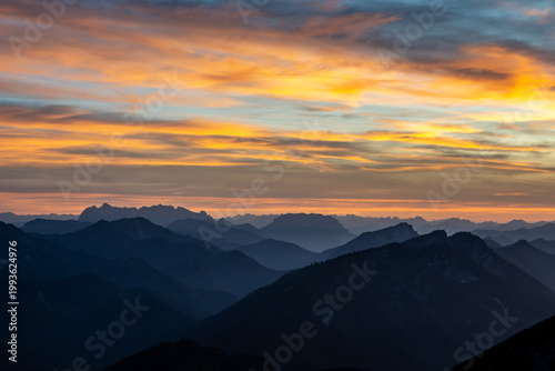 view from peak of Zwiesel over chiemgau alps toward Wilder Kaiser mountain range at sunset, bavaria, germany