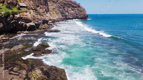 Waves crash into cliff on coastline. This video is from El Salvador, in central America. This is a clif in the coastale town of El Zonte. 