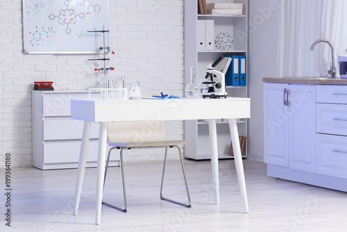 Scientist's desk with microscope and water samples in laboratory