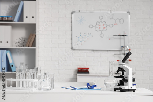 Scientist's desk with microscope and water samples in laboratory