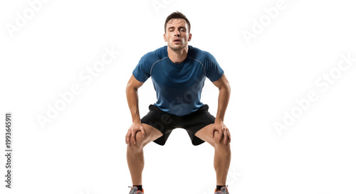 Man in blue shirt and black shorts doing squat exercise