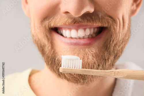 Young bearded man brushing ...