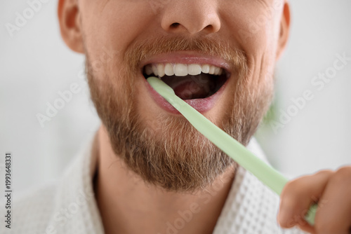 Young bearded man brushing ...