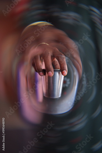 Close-Up of Hand Holding Metal Cup with Tea – Sci-Fi Mood and Dramatic Light