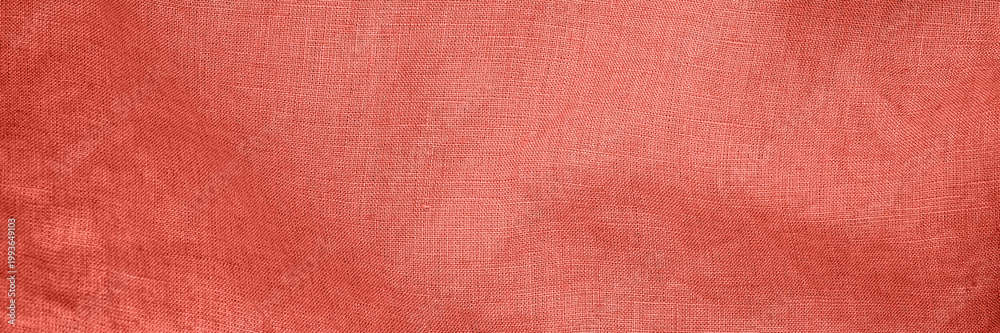 Fototapeta premium Fabric with textured pattern in warm coral shade creating a cozy and inviting atmosphere in a soft setting