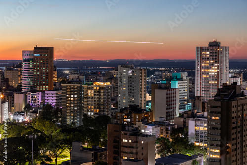 Moinhos de Vento neighborhood at sunset and first night lights and airplane lights
