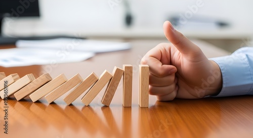 Business Professional Stopping Domino Effect with Hand Representing Risk Management and Crisis Control