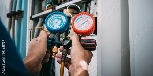 Technician is checking air conditioner refrigerant leak.