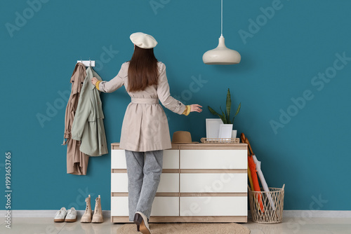 Young woman with clothes, c...
