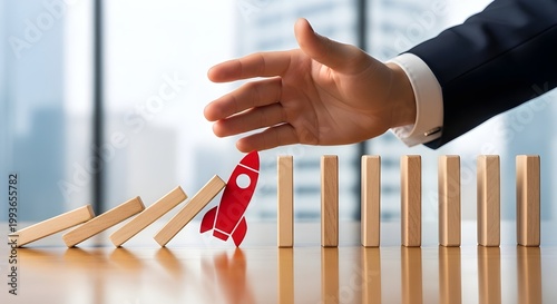 Businessman Hand Protecting Red Rocket Icon from Domino Effect Symbolizing Startup Innovation and Growth Recovery