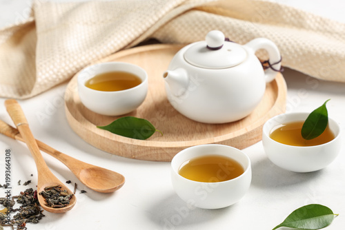 Teapot with cups of green t...